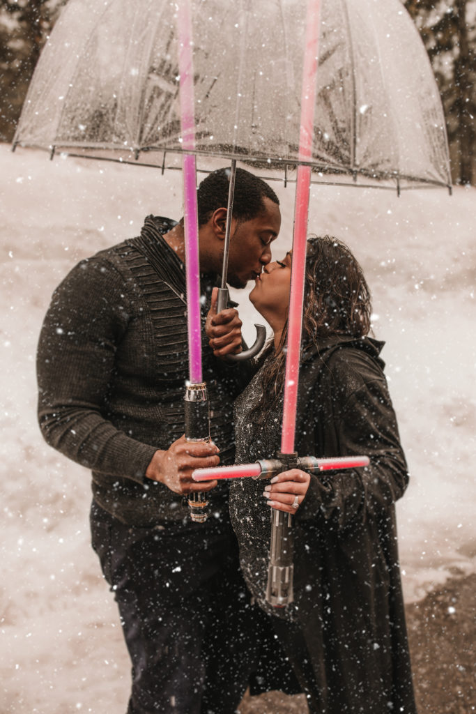 Couple kissing with lightsabers 